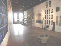 View into loft with  "Galveston Magnolias" hanging above the stairwell.